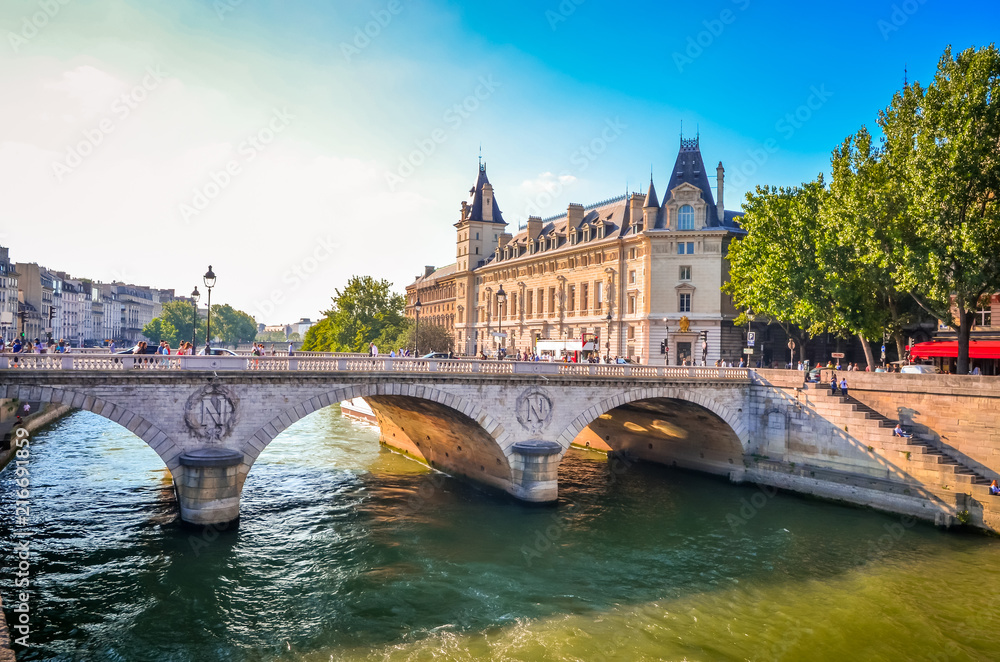 Sunset view on bridge and buildings on the Seine river in Paris, France