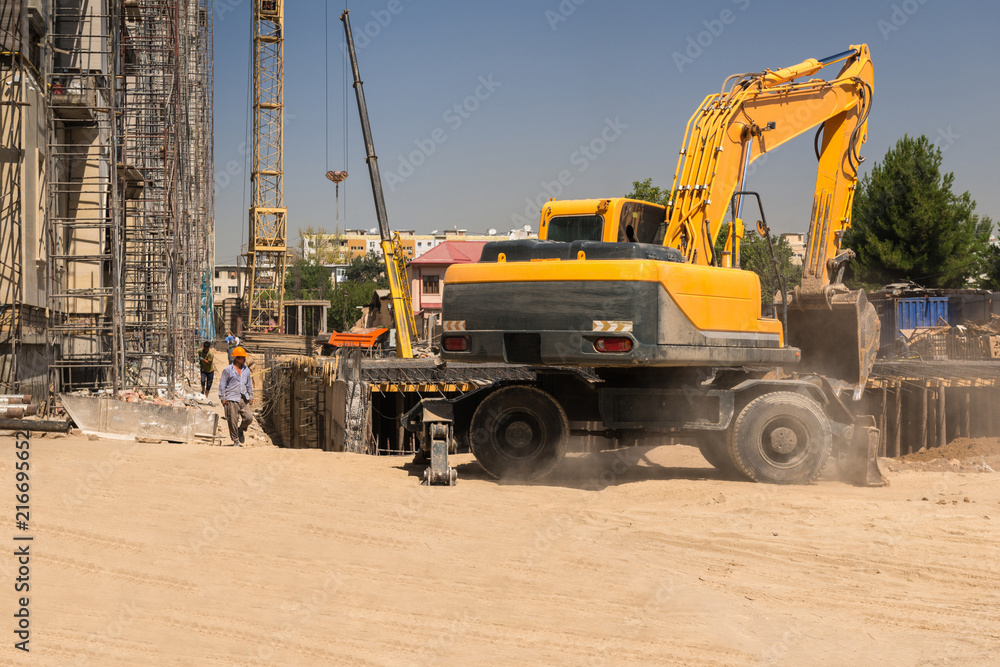 excavator and cranes on the construction site