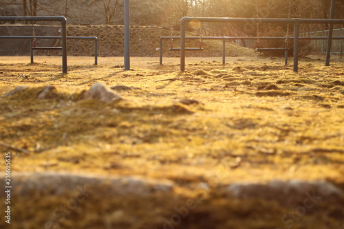 lonely swing in gold light of sun