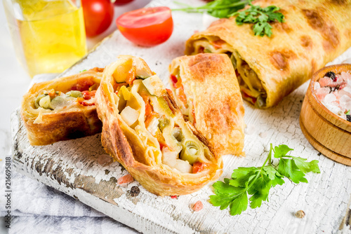 Obraz na plátně Vegetable savory strudel, homemade autumn baking, with tomatoes, bell pepper, mu