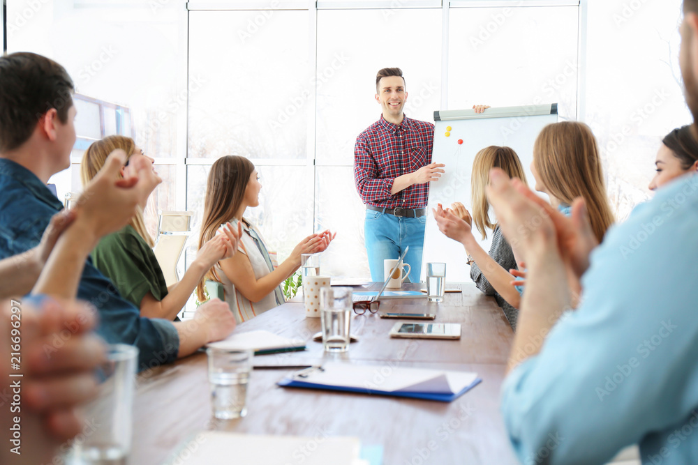 Fototapeta premium Male business trainer giving lecture in office