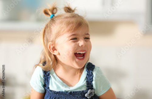 Funny little girl smiling indoors