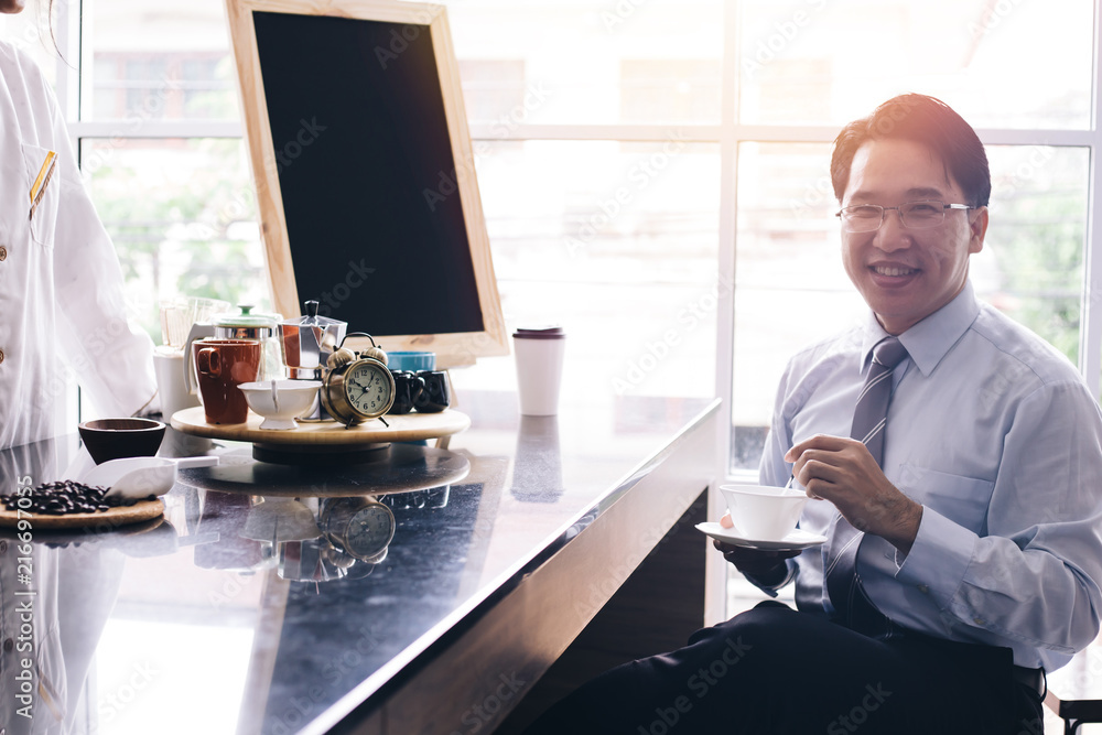 Asian smart businessman as male customer drinking coffee at cafe restaurant Asian smart businessman as male customer drinking coffee at cafe restaurant