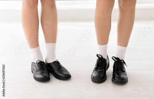 Girls in stylish school uniform indoors, focus on legs