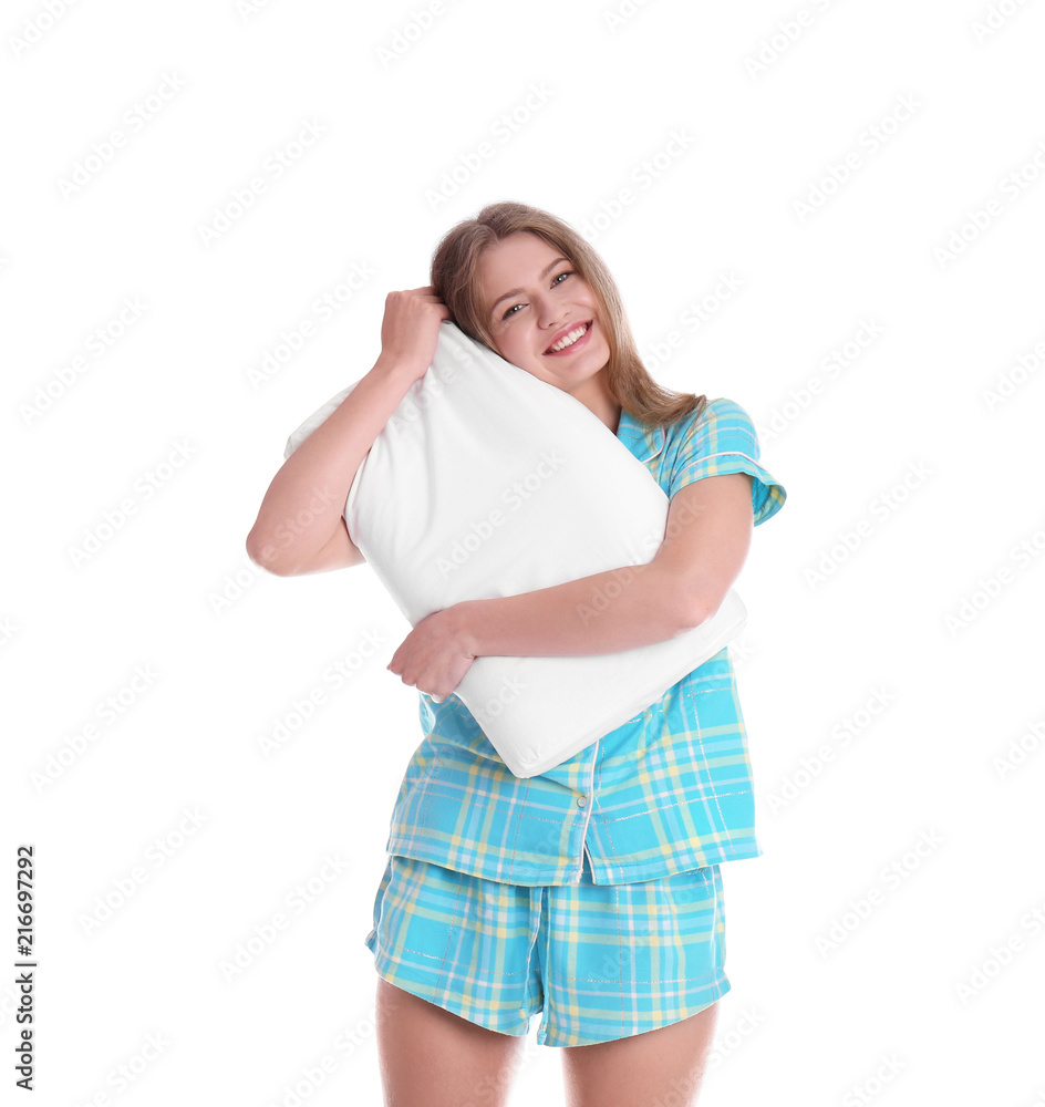 Young woman in pajamas embracing pillow on white background Young woman in pajamas embracing pillow on white background