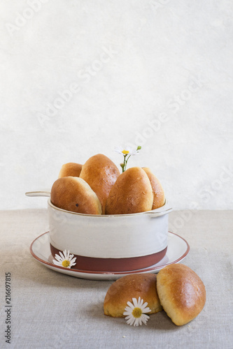 Pirozhki - baked  buns made from yeast dough and glazed with eggs, with cabbage and tomatoes filling, typical for Russia and Ukraine. photo