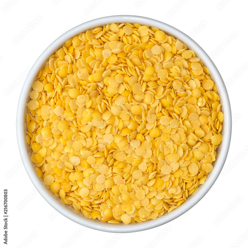Beans of dry yellow split lentils in white bowl isolated on white background. Top view. Beans of dry yellow split lentils in white bowl isolated on white background. Top view.
