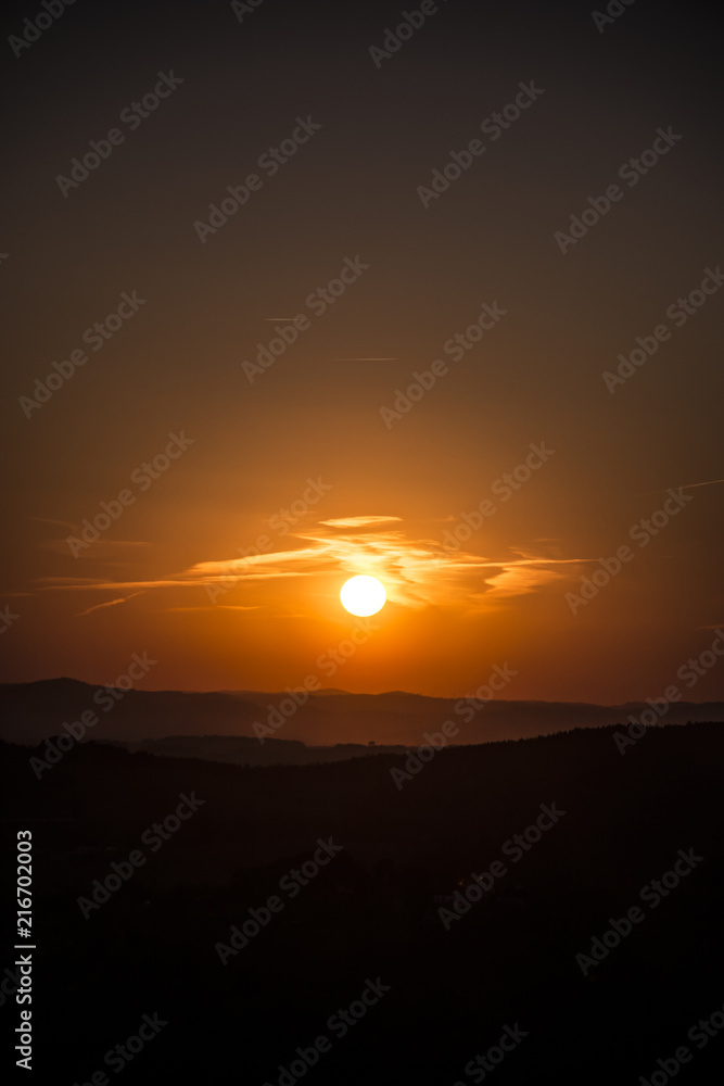 Fototapeta premium Red sky with clouds during sunset. Sun is very nearby Earth.
