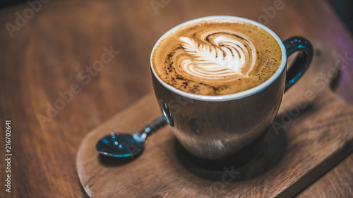 Hot Latte Cup On Wooden Saucer photo