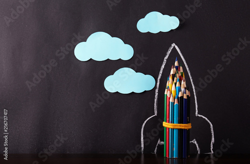 Rocket on black background. Back to school concept