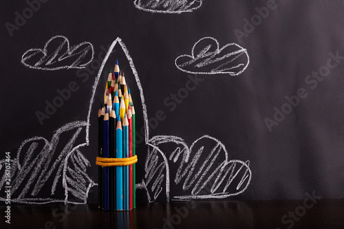 Rocket on black background. Back to school concept