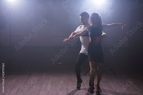 Active happy adults dancing bachata together in dance class