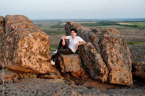 tourist and model at the top of the mountain enjoying the sunset over the tropical valley, posing in front of the camera  © александр таланцев