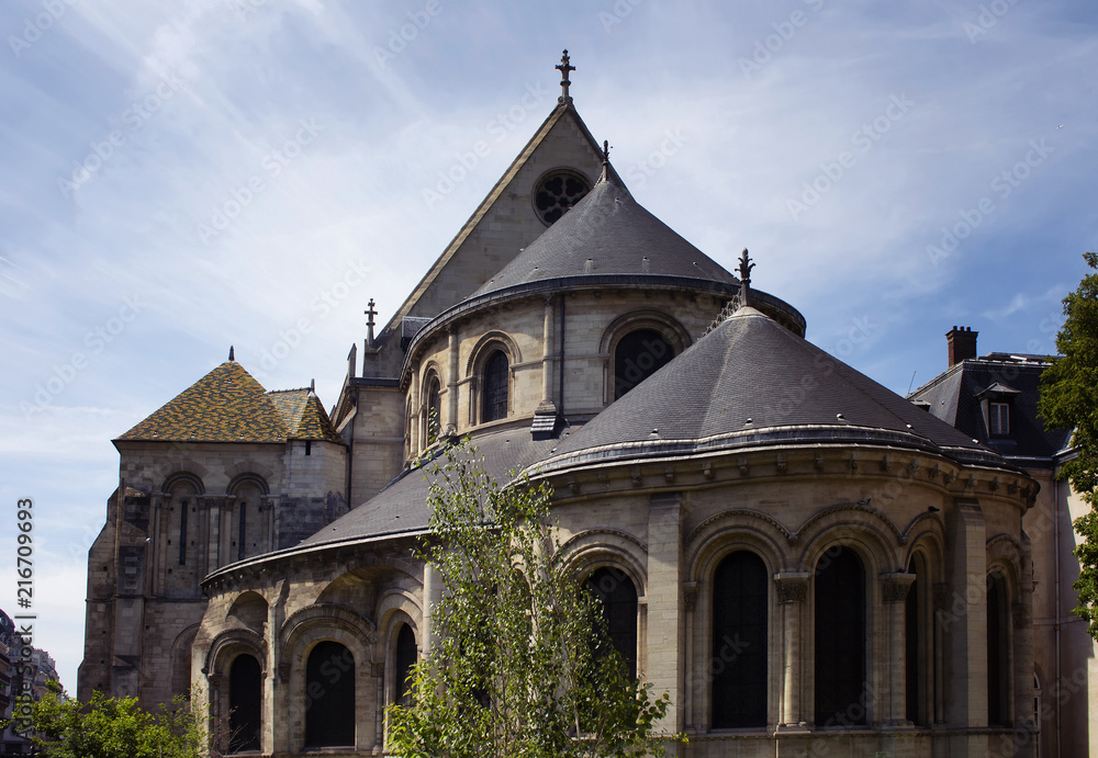 View of a traditional, historical building in Paris showing Parisian / French architectural style. It is a sunny day in spring. 3rd arrondissement