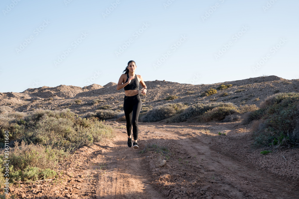 Woman running in the desert on a sunnyday