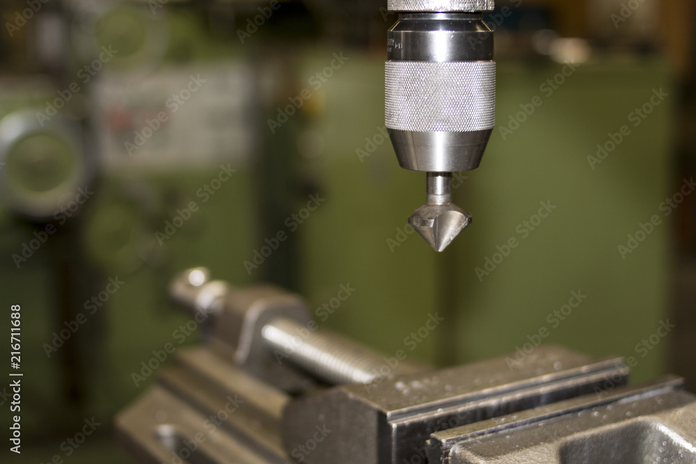 Industrial classic green machine with vice in workshop for metal craft work with exchangeable countersink drill bit Industrial classic green machine with vice in workshop for metal craft work with exchangeable countersink drill bit