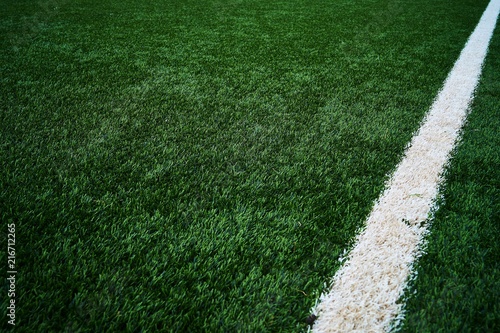 Artificial green grass football / soccer field / pitch & white stripe - close up