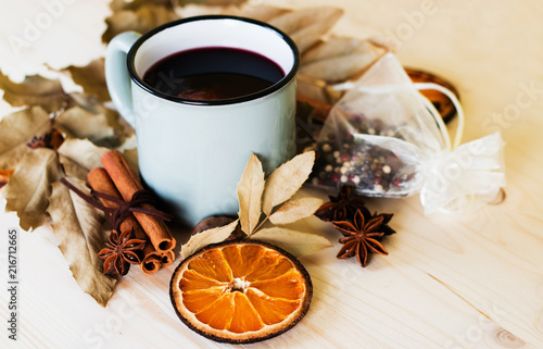 Autumn, fall leaves, hot steaming cup of glint wine