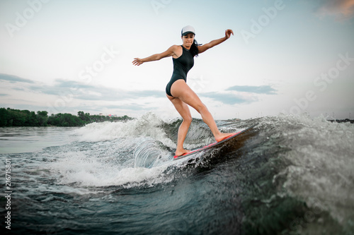 Rear view young active woman riding on the wakesurf © fesenko