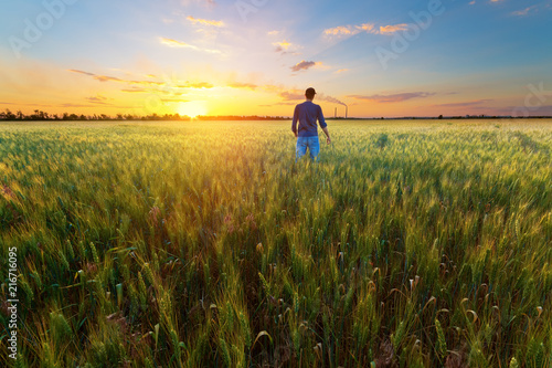 photographer while working search for a story / evening landscape man on the field