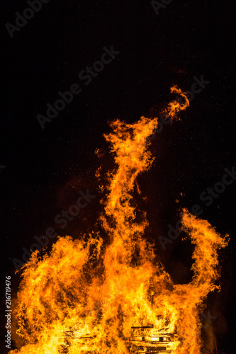 Fire flames with sparks and ember on black background