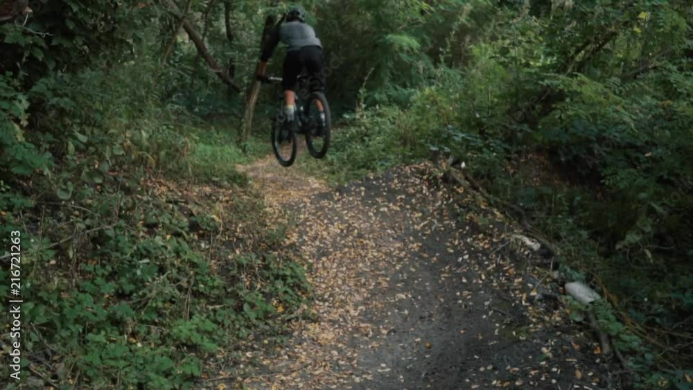 extreme bicyclist rides on forest path, slow motion extreme bicyclist rides on forest path, slow motion