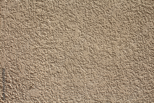 A textured beige plaster's wall as a background