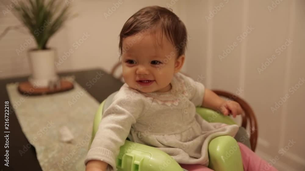 Cute Baby Girl Smiling, Sitting Happily on Table Cute Baby Girl Smiling, Sitting Happily on Table