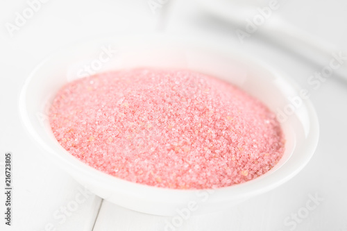 Red jelly or jello powder in small bowl on white wood (Selective Focus, Focus in the middle of the image)