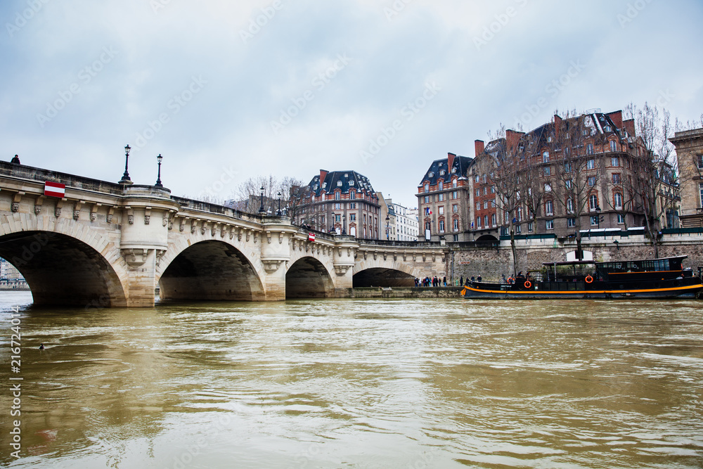 Boat at the Seine river next to the Pont Neuf in a cold winter day in Paris Boat at the Seine river next to the Pont Neuf in a cold winter day in Paris