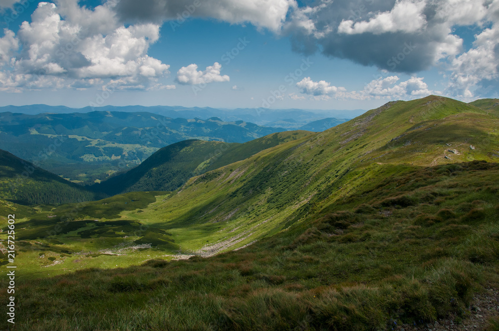Amazing mountain landscape in vivid sunny day, natural outdoor travel background. Dramatic and picturesque scene of Carpathian mountains in Ukraine. Amazing mountain landscape in vivid sunny day, natural outdoor travel background. Dramatic and picturesque scene of Carpathian mountains in Ukraine.