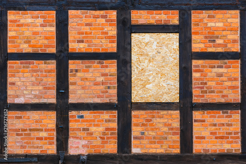 Brown brick wall as grunge background with copy space