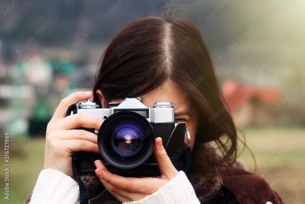 stylish happy girl traveler with photo camera on the background of sunny mountains taking photos stylish happy girl traveler with photo camera on the background of sunny mountains taking photos