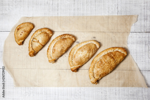 Five Cornish pasty's ranging from cocktail size to large