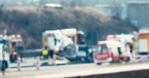 Car accident scene on highway with fire trucks, ambulance and police - out of facuse for background use