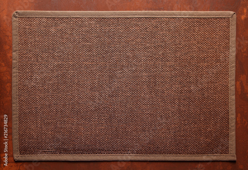 support for a table in restaurant with texture / knitted decorative brown background, with brown frame on brown table 