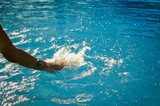 Defocused blurry water splashing on sunny outdoors tropical background. Unfocused recreational blurred happy kids having fun relax on travel vacation summertime.