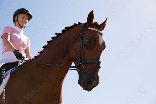 Close up of Young Woman Riding a Horse
