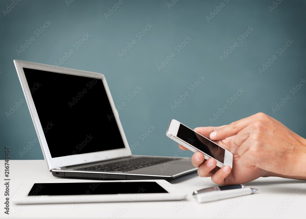Business man hands using mobile and laptop Business man hands using mobile and laptop