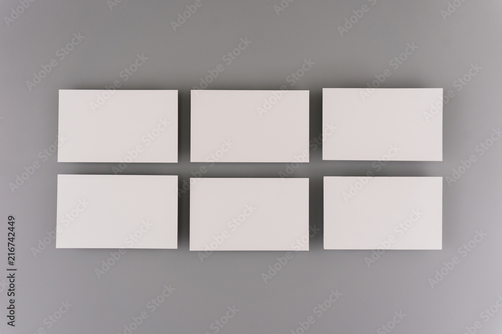 Blank business cards on light background. Mock up for design and branding identity. Blank business cards on light background. Mock up for design and branding identity.
