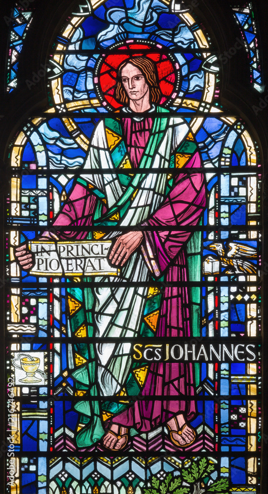LONDON, GREAT BRITAIN - SEPTEMBER 16, 2017: The St. John the Evangelist on the stained glass in church St Etheldreda by Joseph Edward Nuttgens (1952).