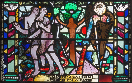 LONDON, GREAT BRITAIN - SEPTEMBER 16, 2017: The Expulsion of Adam and Eve from Paradise on the stained glass in church St Etheldreda by Charles Blakeman (1953 - 1953).