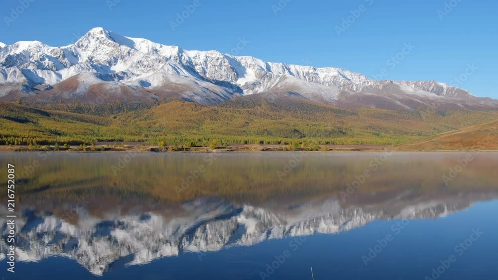 View on Altai lake Dzhangyskol on mountain plateau Eshtykel. North Chuisky ridge is reflecting in the water View on Altai lake Dzhangyskol on mountain plateau Eshtykel. North Chuisky ridge is reflecting in the water