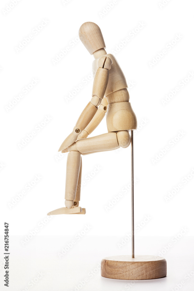 Wooden Dummy human sit down isolated white. Wooden Dummy human sit down isolated white.