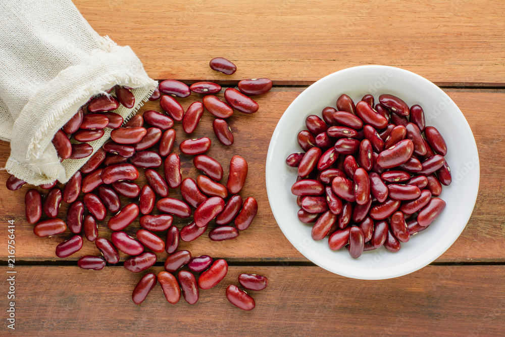 Red beans in sack and bowl on wooden table. Red beans in sack and bowl on wooden table.