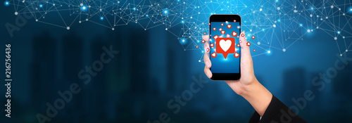 View of a businesswoman holding Like notification on a social media, social media concept