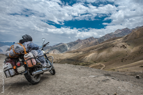 Scenic view of road by landscape with mountain, road and blue sky seen through motor bike, Leh is a town in the Leh district of the Indian state of Jammu and Kashmir.