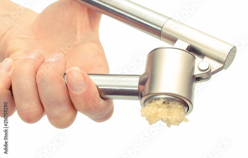 Hand of woman squeezing fresh garlic on white background