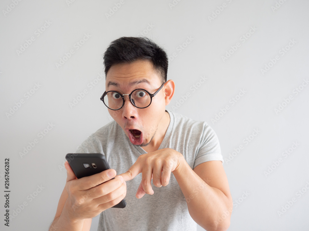 Wow face of man shocked what he see in the smartphone. Wow face of man shocked what he see in the smartphone.