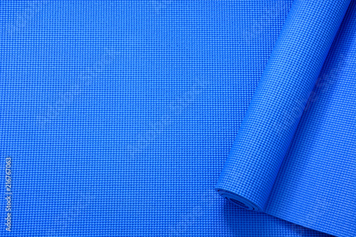 close up roll blue color yoga mat texture background,top view, copy space, healthy lifestyle, sport and  exercise concept